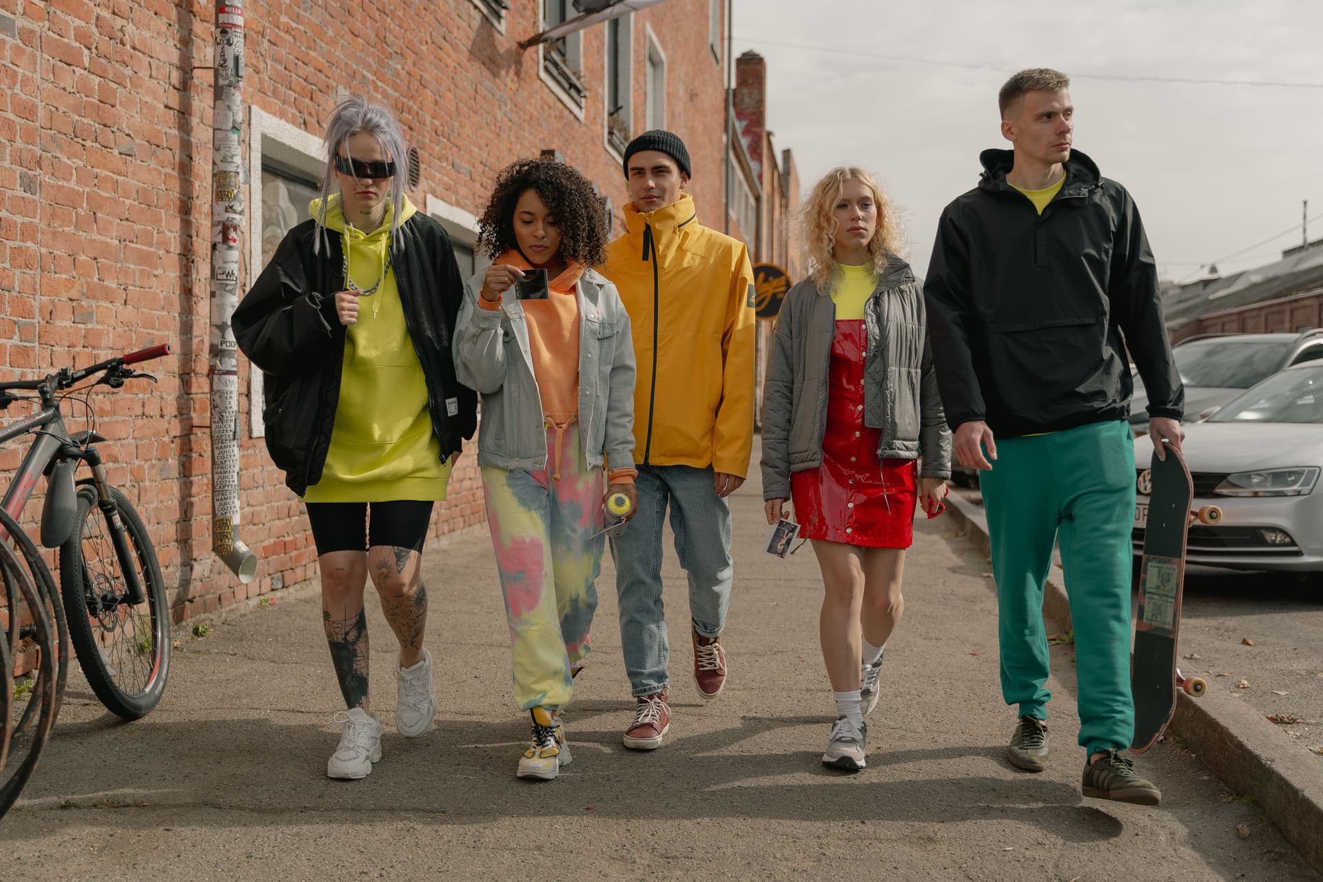 Three models wearing MAIDYN outerwear styling in the city